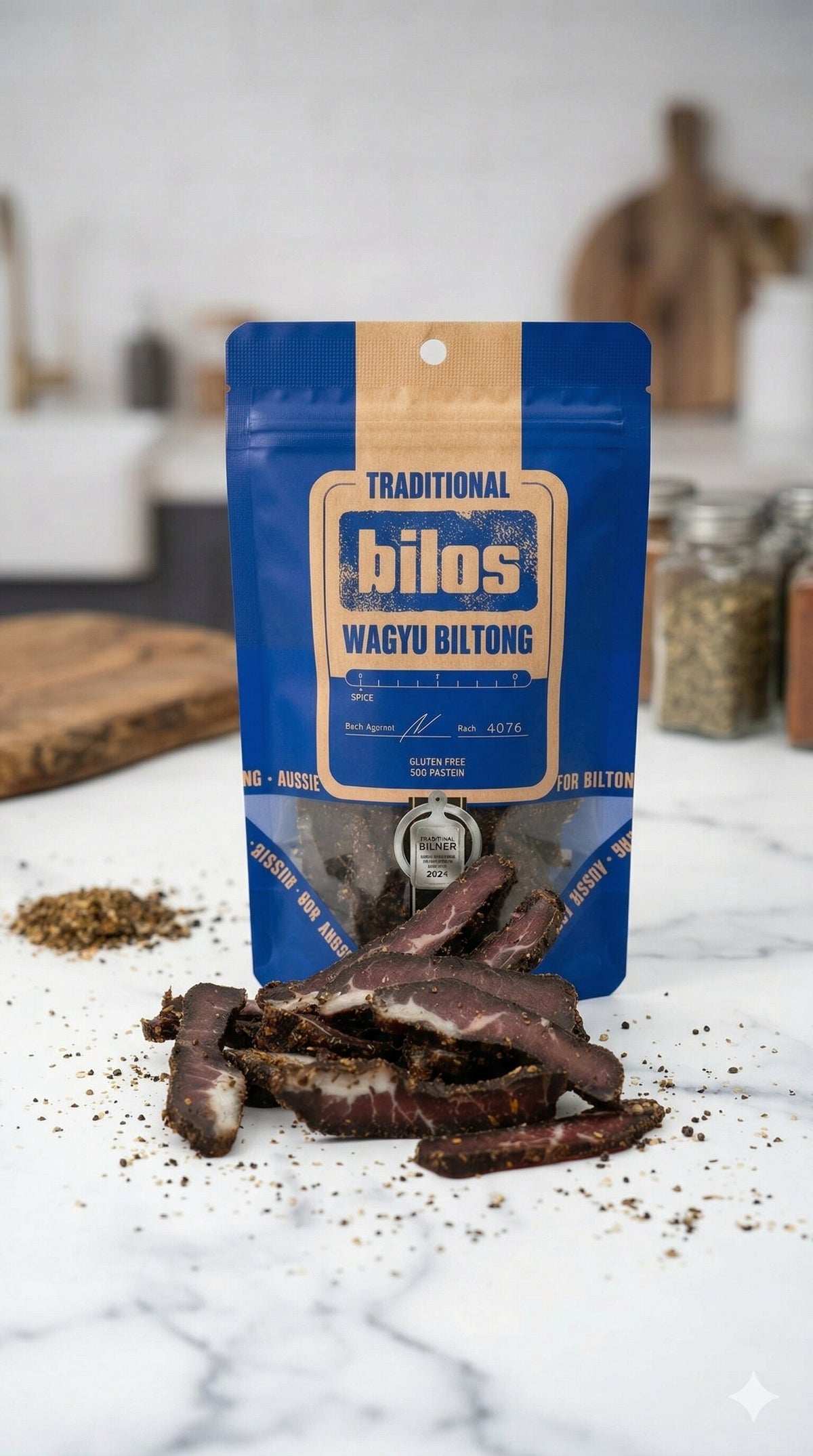 Bilos Wagyu Biltong packaging on a marble surface with biltong slices and spices.